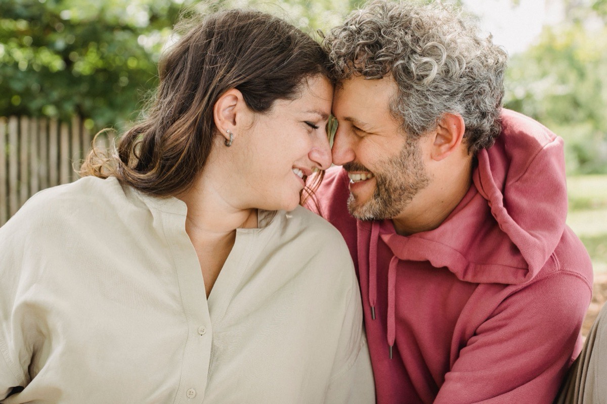 Mature couple touching foreheads and smiling outdoors